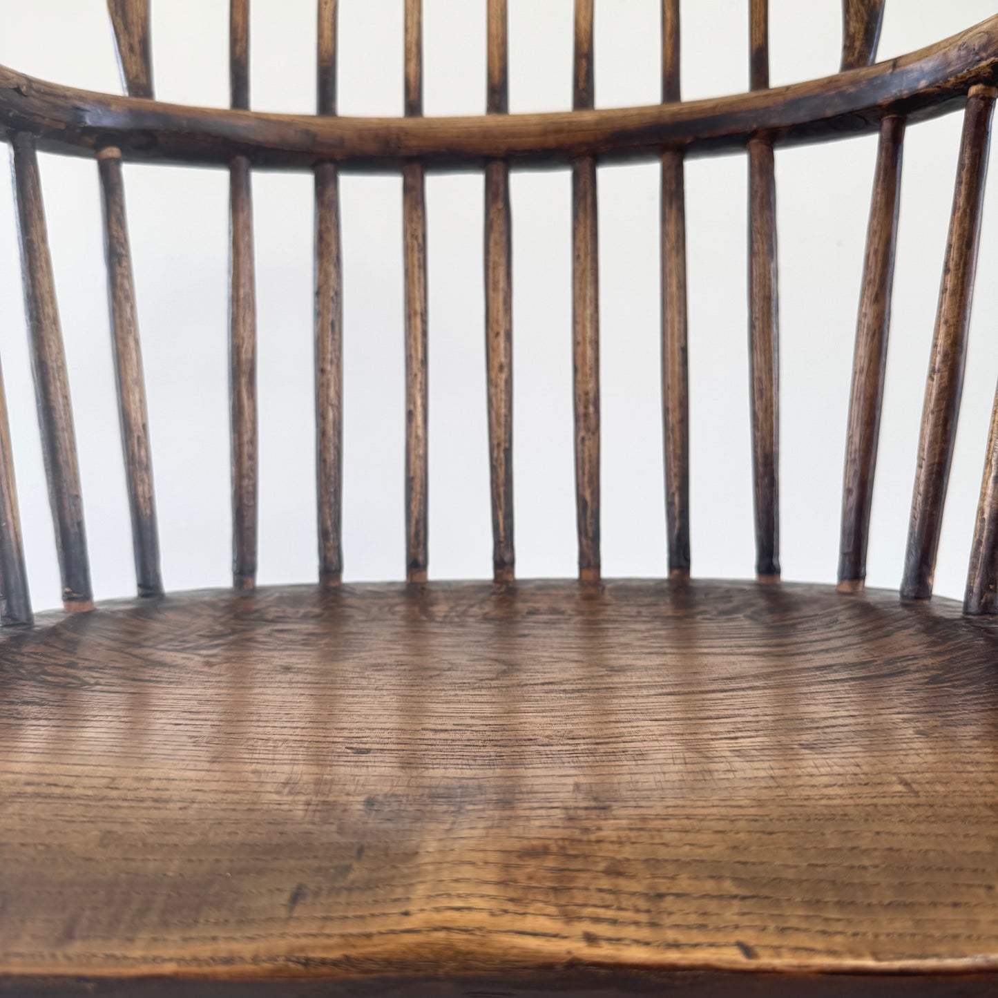 An 18th century elm seated spindle back Windsor armchair.