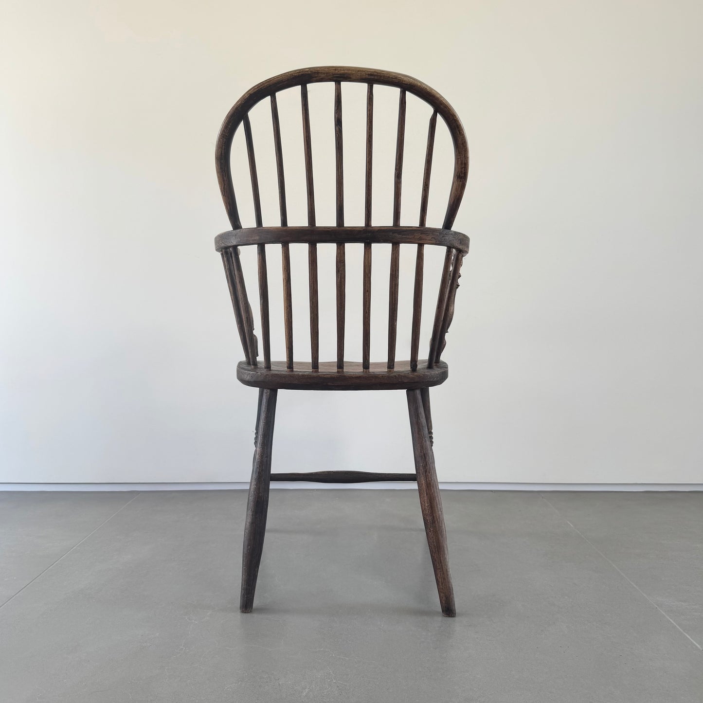 An 18th century elm seated spindle back Windsor armchair.