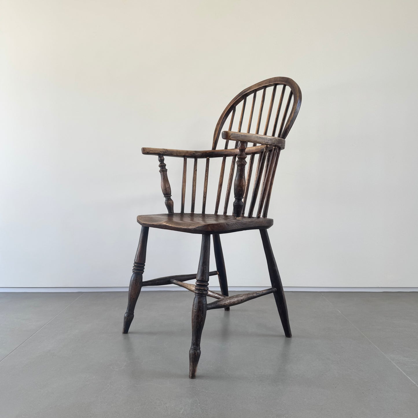An 18th century elm seated spindle back Windsor armchair.