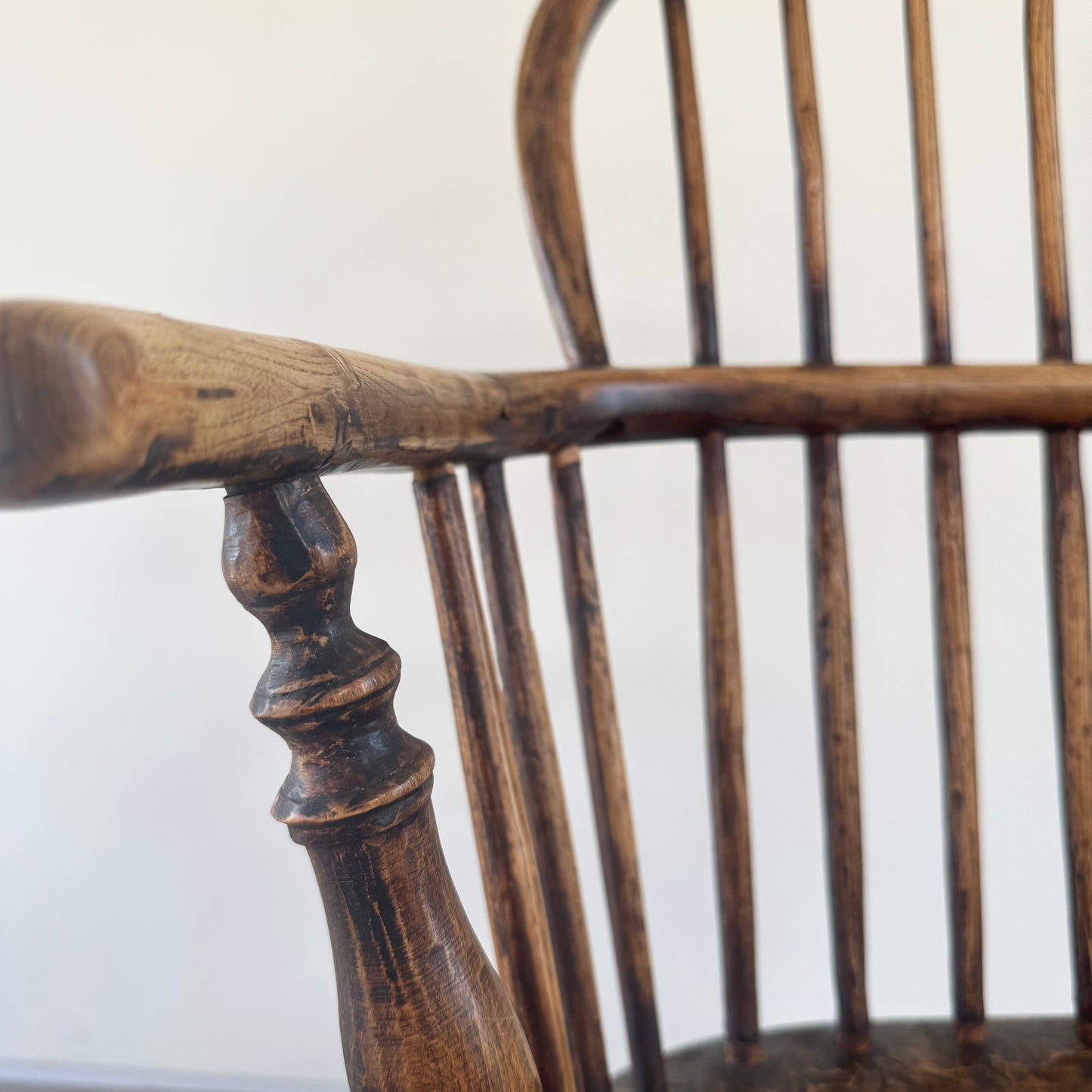 An 18th century elm seated spindle back Windsor armchair.