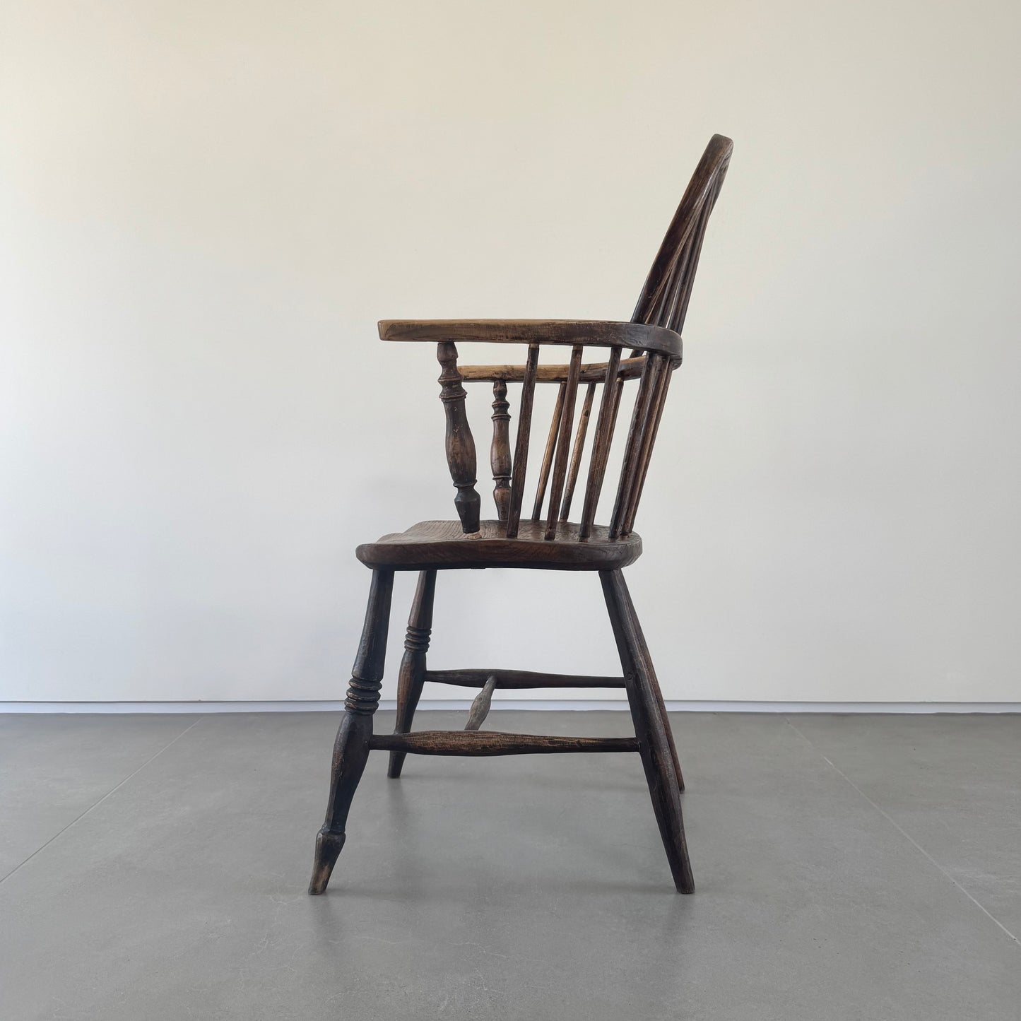 An 18th century elm seated spindle back Windsor armchair.