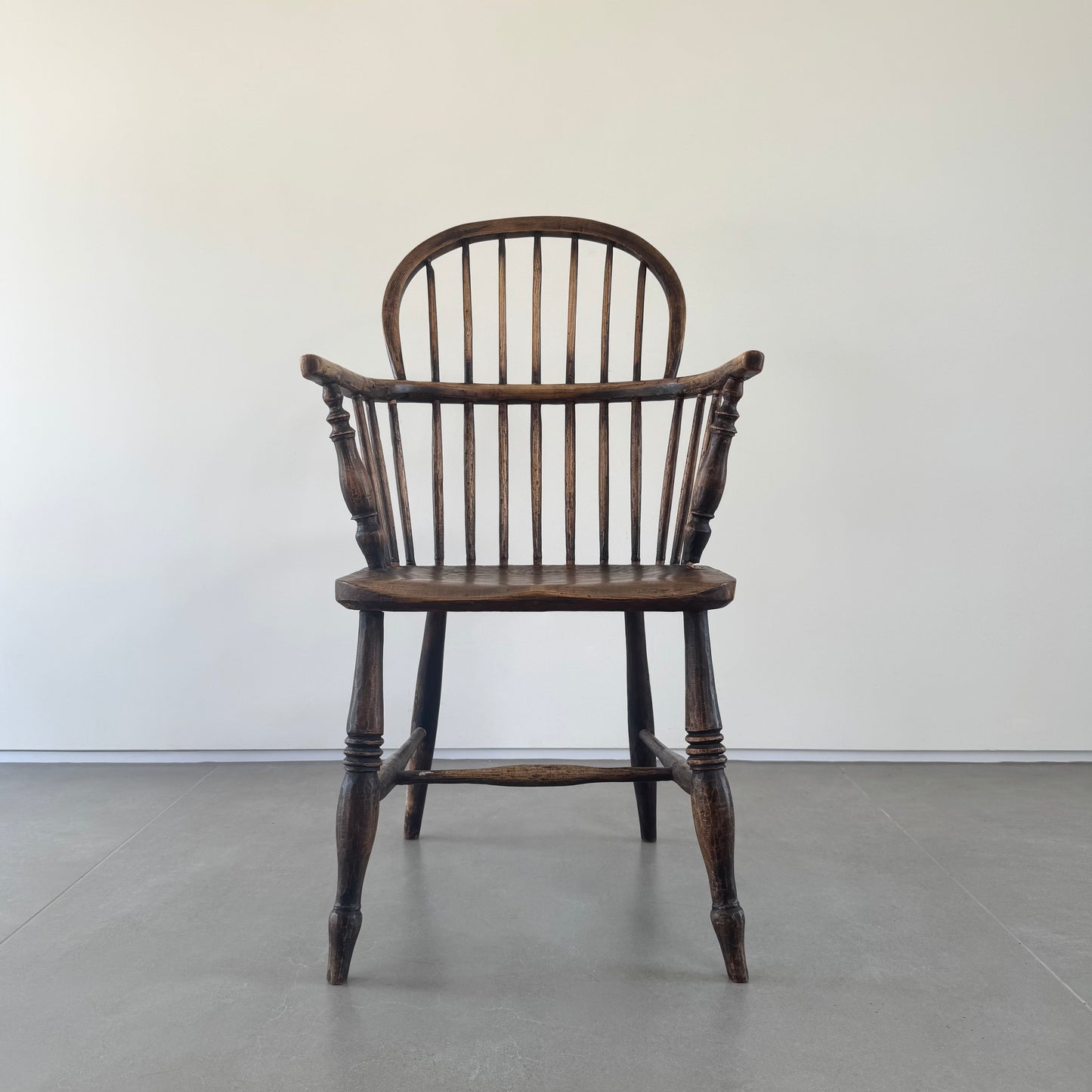 An 18th century elm seated spindle back Windsor armchair.