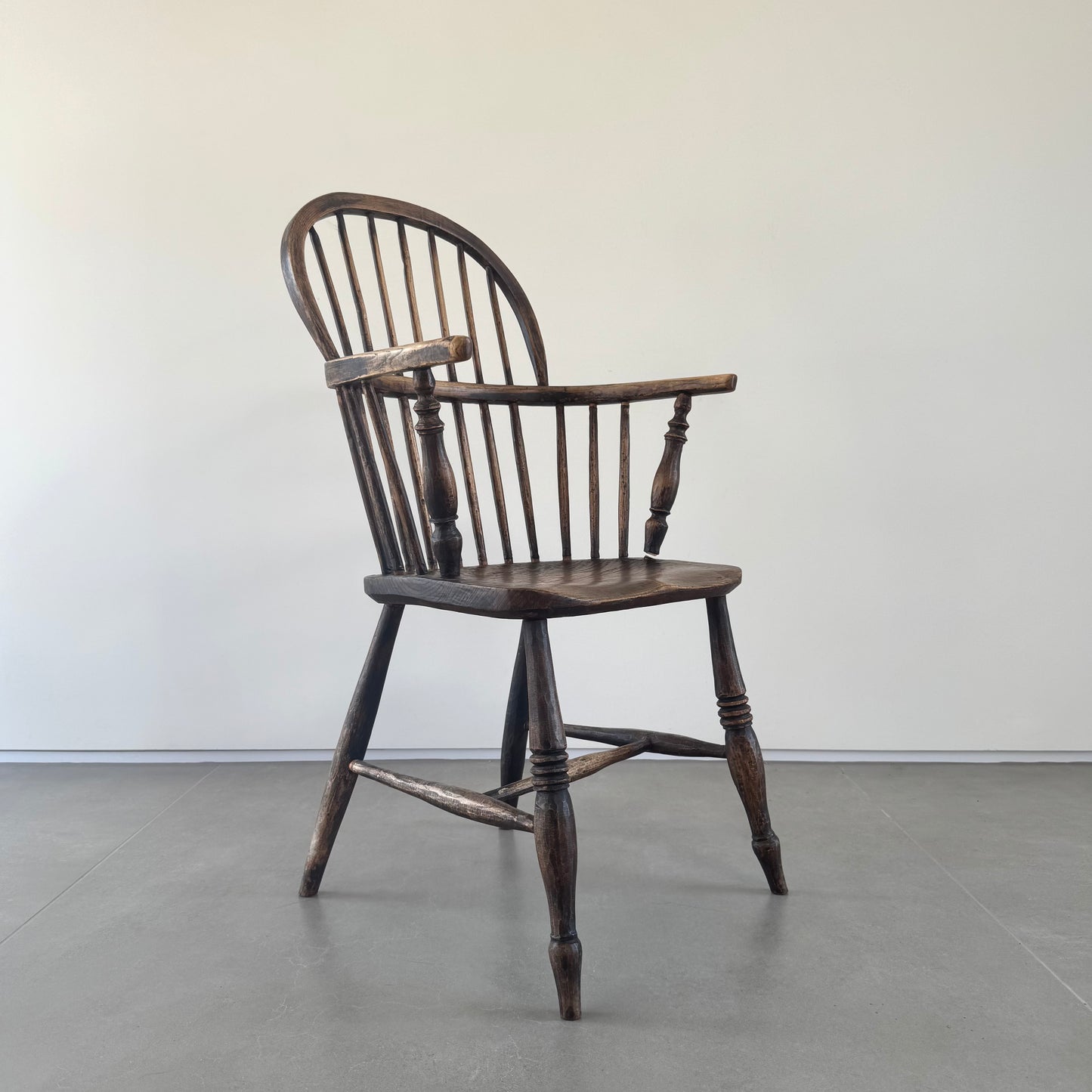 An 18th century elm seated spindle back Windsor armchair.